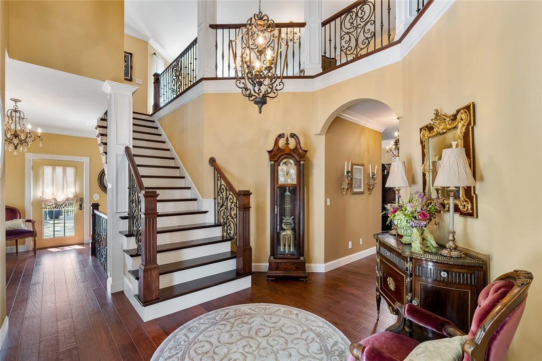 Image 4: A grand entrance welcomes you with rich hardwood f