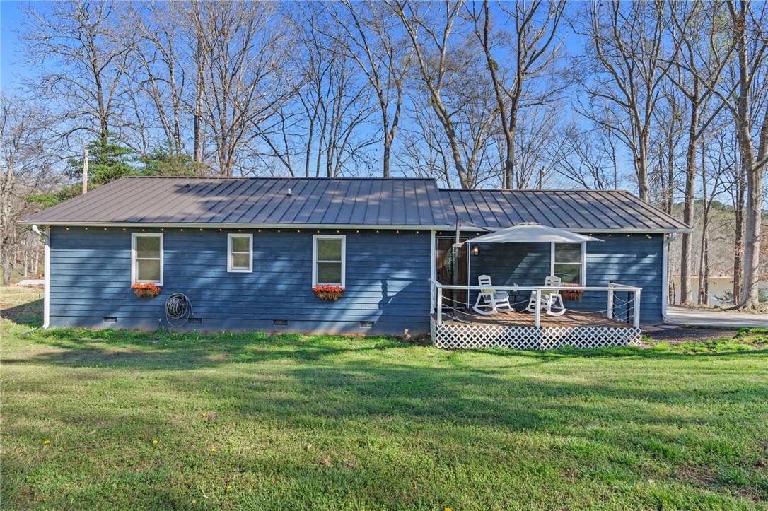 Image 4: This inviting home features a welcoming porch, per
