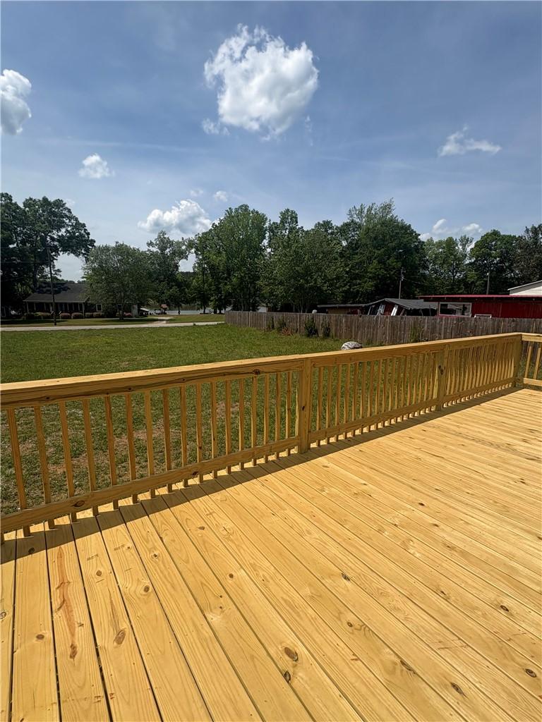 Image 3: This spacious deck overlooks a serene outdoor spac