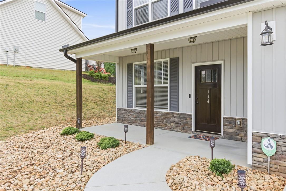 Image 4: The welcoming entrance features a charming covered