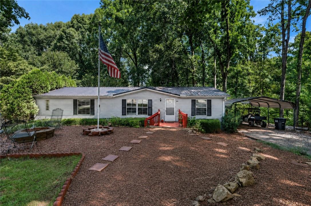 Image 1: A quaint residence nestled amidst lush trees, feat