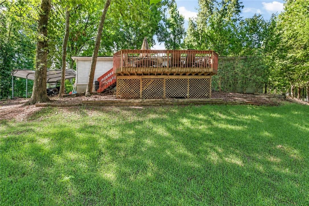 Image 3: A spacious wooden deck provides an elevated outdoo