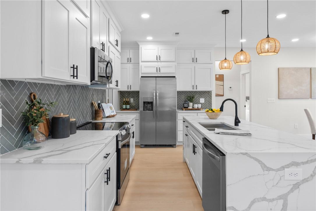 Image 4: Bright and inviting kitchen with an island for eff