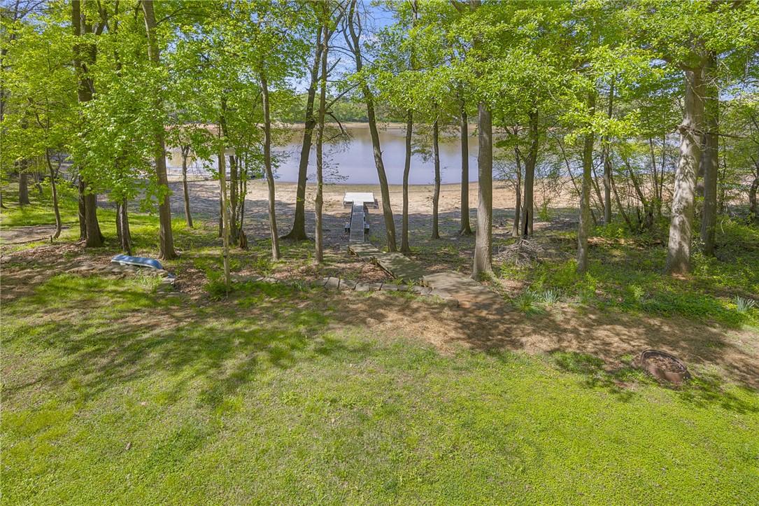 Image 3: This serene waterfront lot features a private dock
