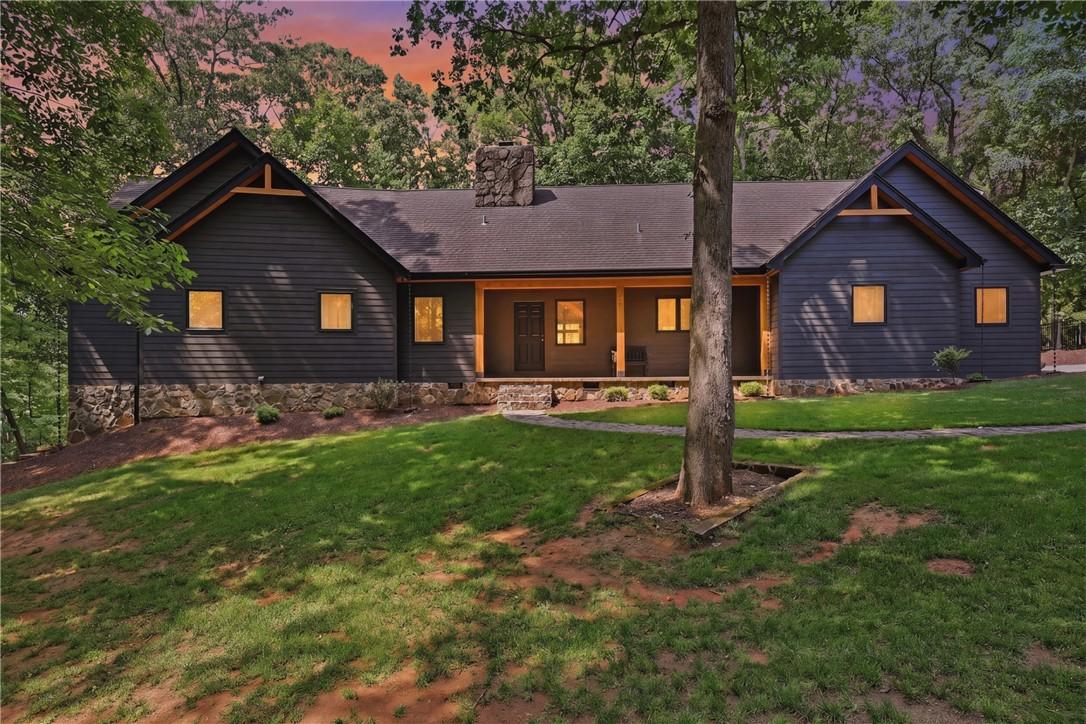 Image 1: This captivating home features a blend of natural