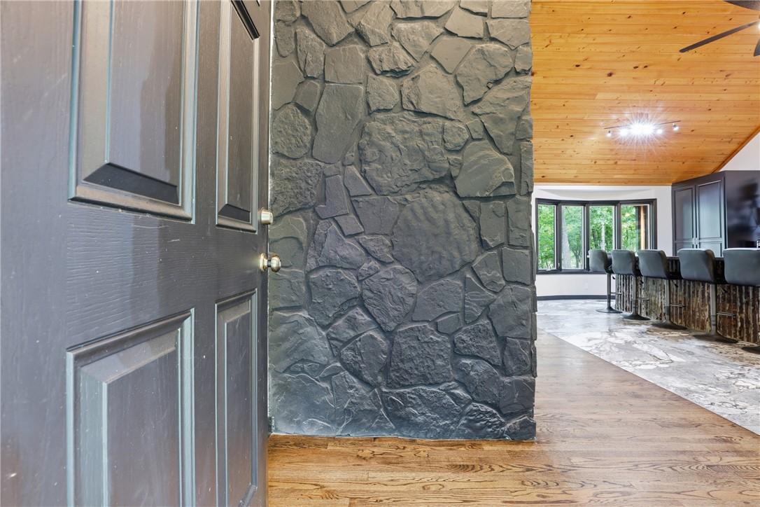 Image 2: This interior entry features rich hardwood floors