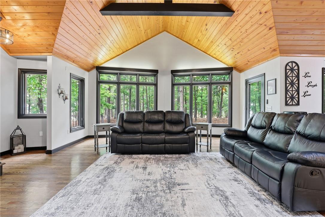 Image 3: This living room offers serene woodland views thro