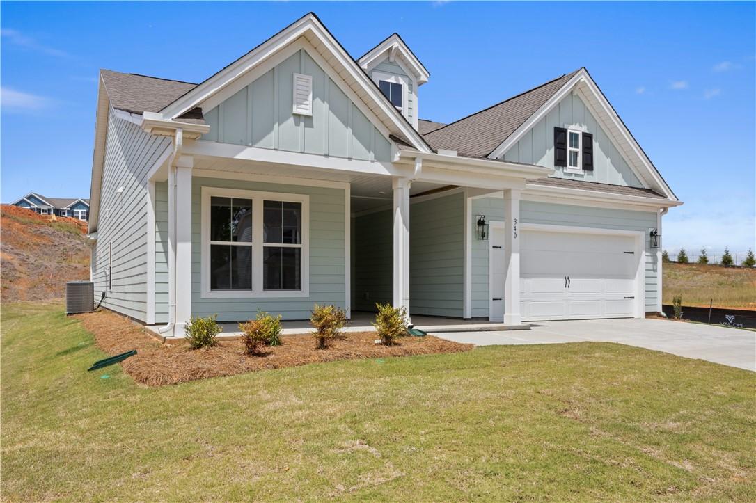 Image 2: A charming residence with a covered entry and a cl
