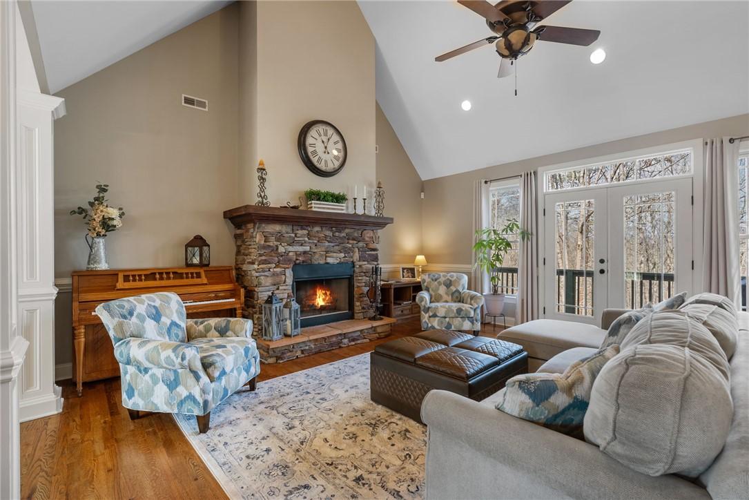 Image 3: This inviting living room features a stone firepla