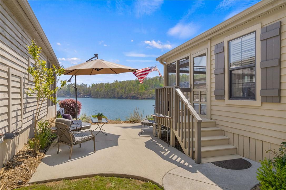 Image 3: This inviting patio area offers serene waterfront