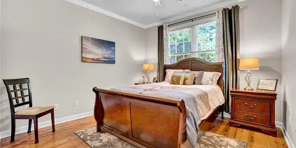 Image 3: This spacious bedroom offers gleaming hardwood flo