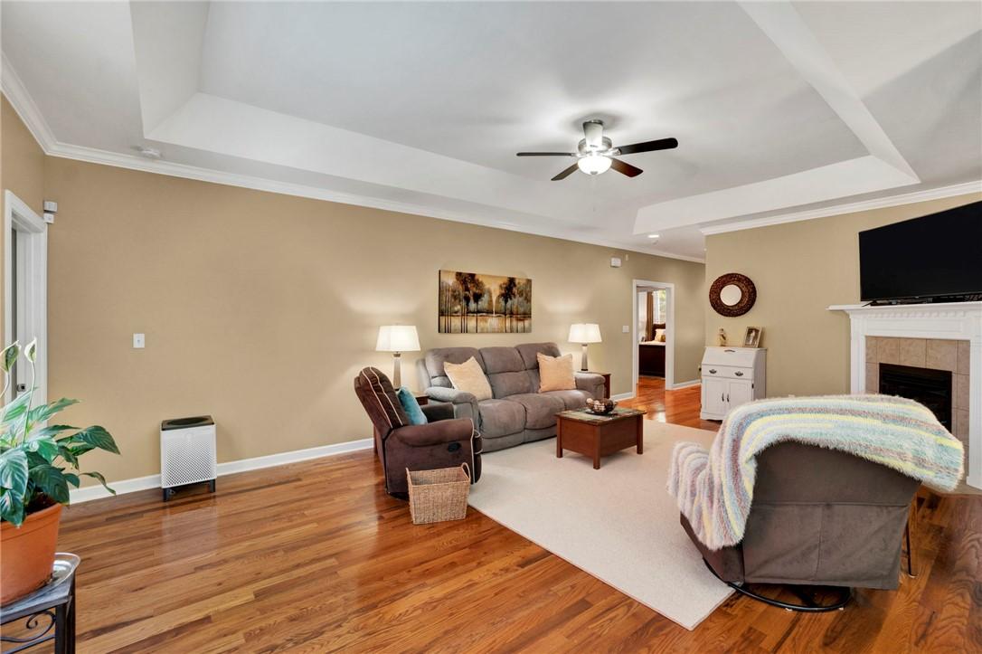 Image 4: This inviting living space features warm wood floo