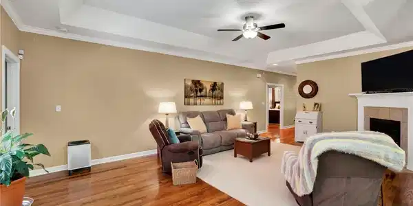 Image 4: This inviting living space features warm wood floo