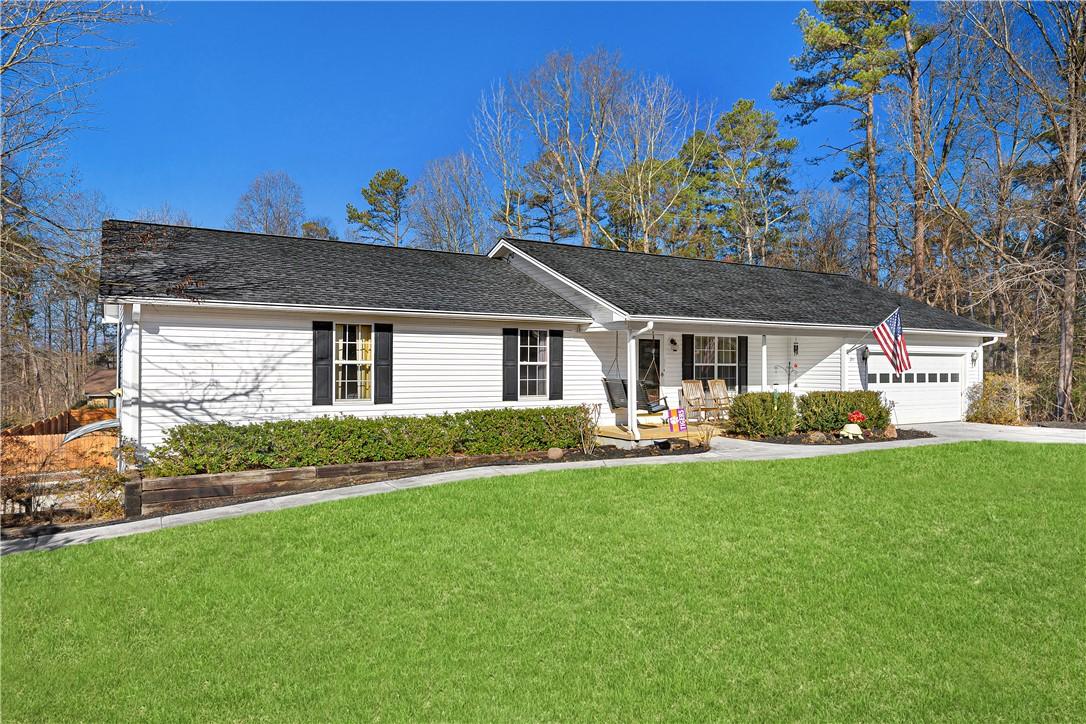 Image 1: This charming home offers a welcoming facade with