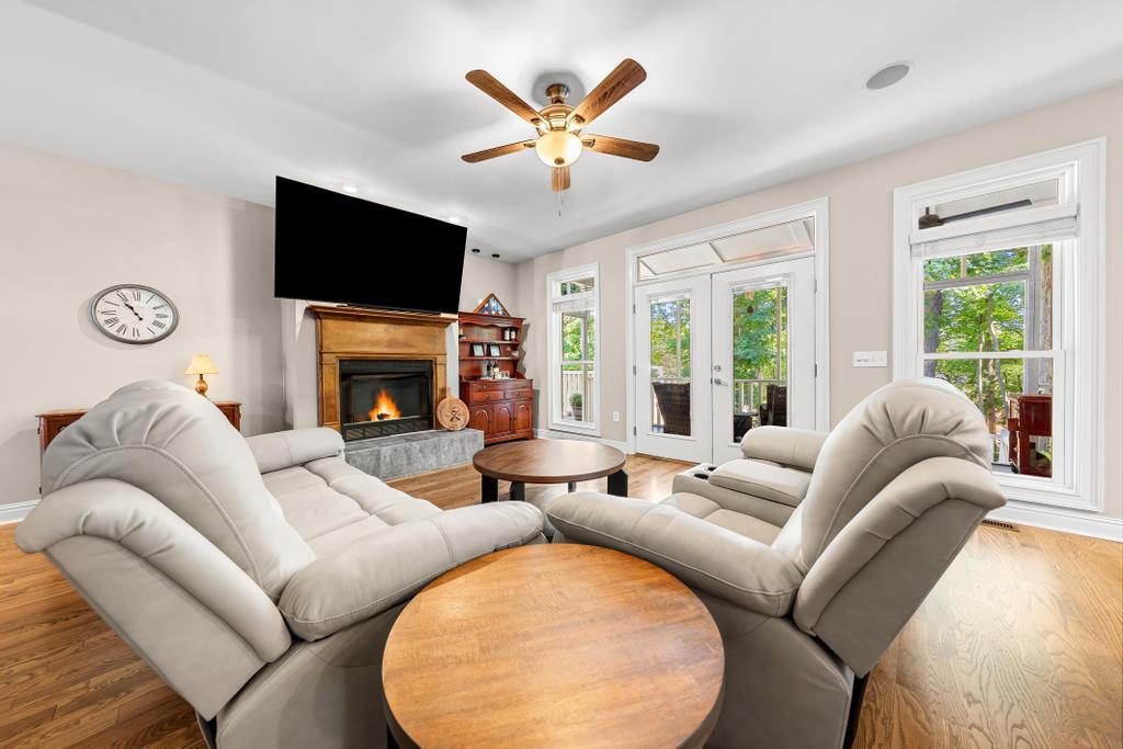 Image 3: A comfortable living room featuring a warm firepla