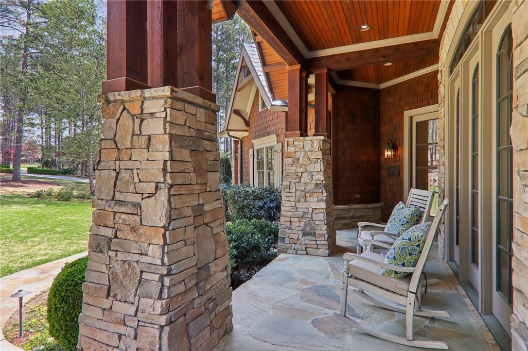 Image 2: This inviting porch, adorned with natural stone an