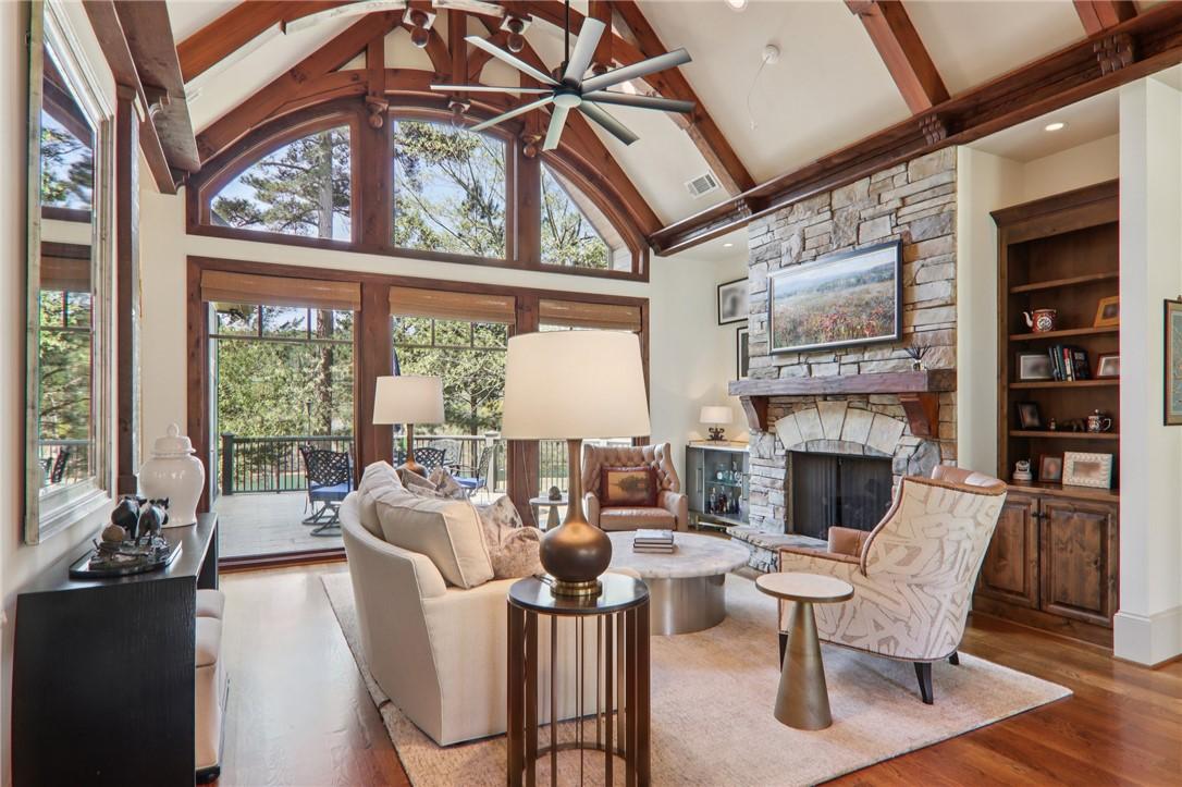Image 4: This grand living area features expansive windows,