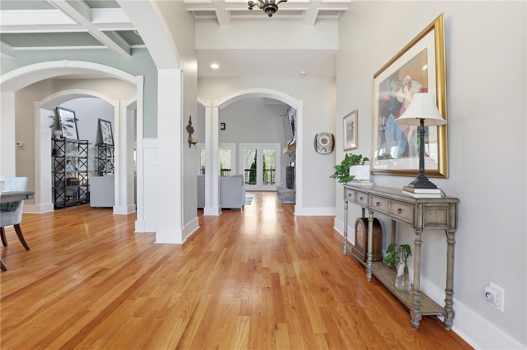 Image 3: The bright foyer features a coffered ceiling and h