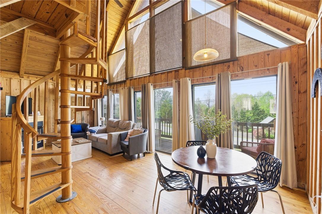Image 3: This airy space showcases soaring ceilings, a spir