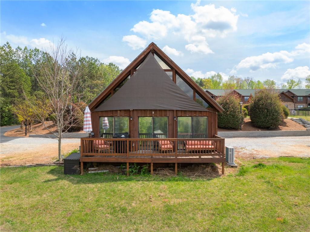 Image 4: This charming A-frame cabin offers a spacious deck
