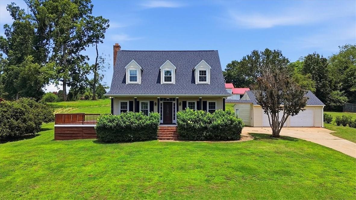 Image 1: A charming dwelling with a welcoming front porch,