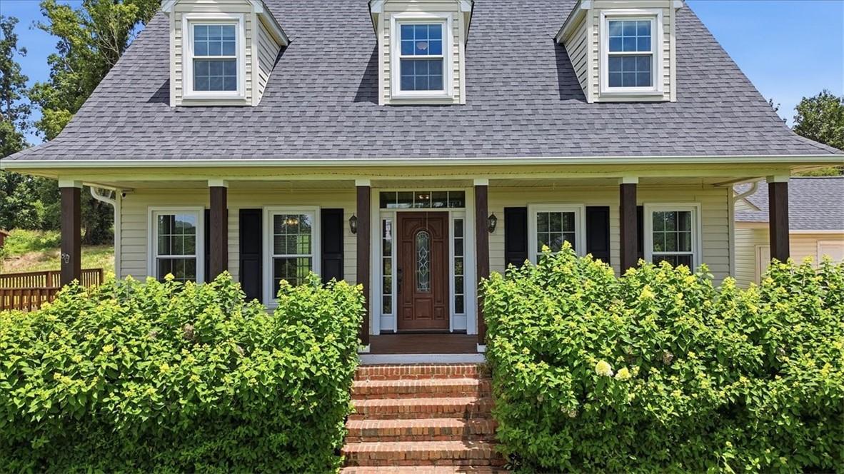 Image 3: A welcoming brick staircase leads to a charming fr