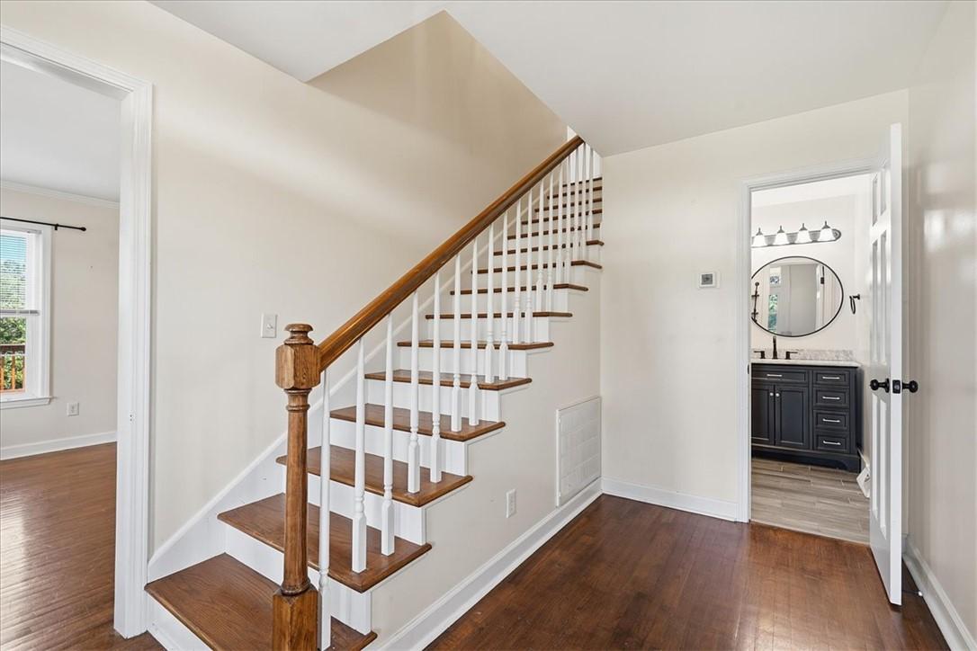 Image 4: Rich hardwood floors welcome you into this invitin