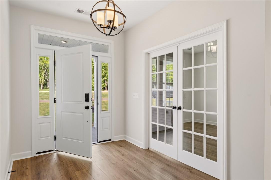 Image 3: Step inside this inviting home featuring an elegan