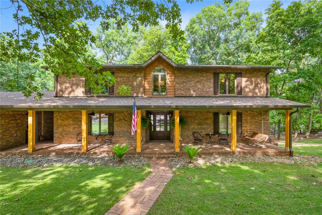 Image 1: A classic brick exterior with a welcoming porch an