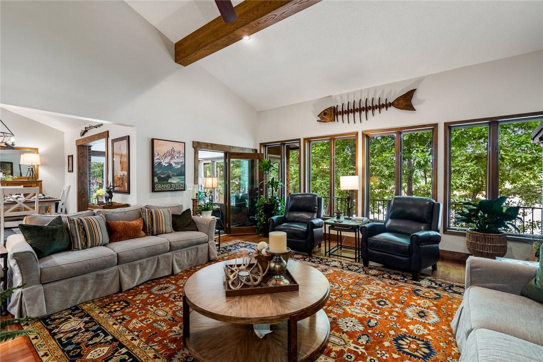 Image 3: A well-lit great room features high vaulted ceilin