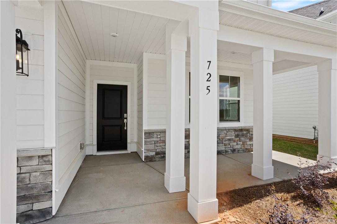 Image 3: A welcoming front porch features classic white col
