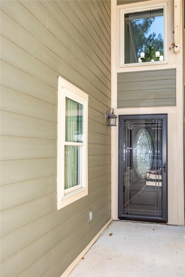 Image 3: A welcoming entry features durable siding and a de