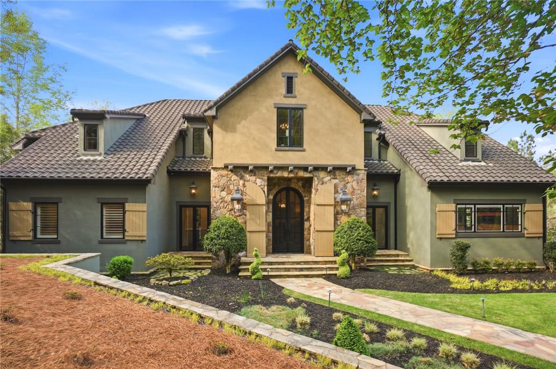 Image 4: This home features a captivating facade with stone