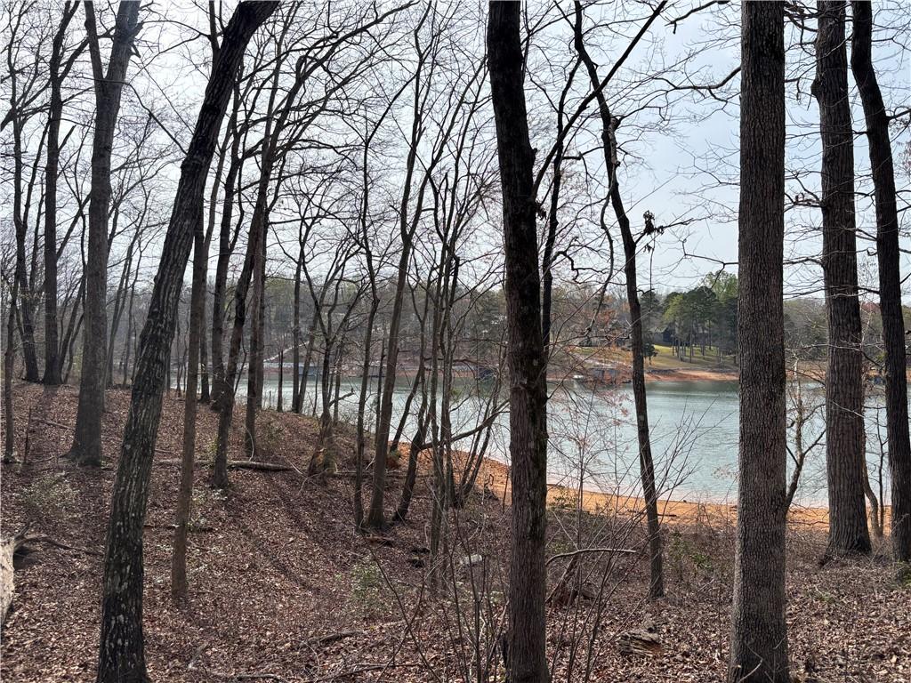 Image 1: This serene waterfront lot offers tranquil views t