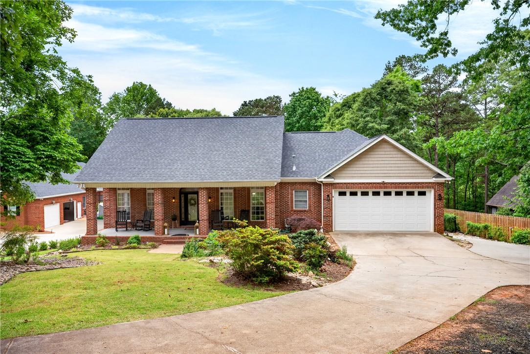 Image 1: This classic brick residence features a welcoming