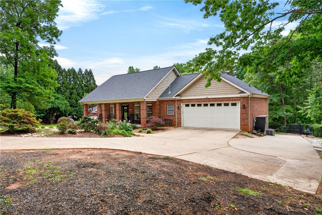 Image 2: This classic brick residence features a welcoming