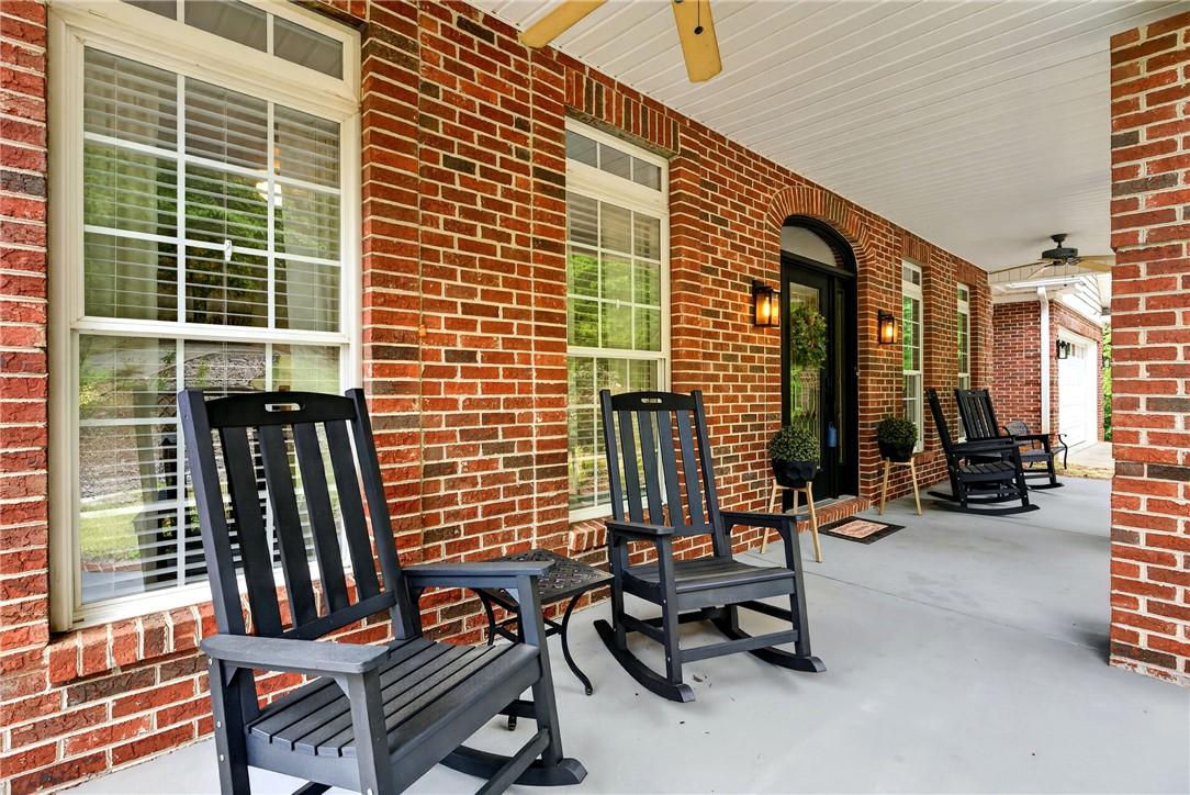 Image 4: This inviting porch, framed by classic brick, offe