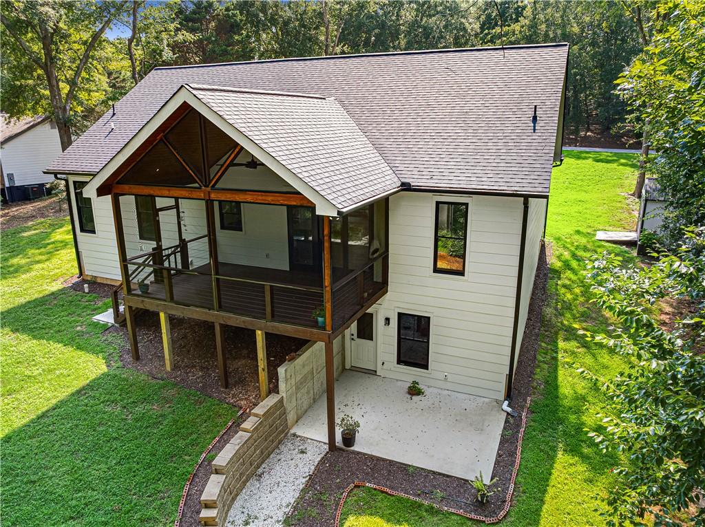 Image 3: A elevated screened porch extends from this inviti