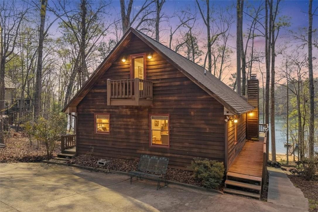 Image 1: This charming cabin home offers serene lakefront l
