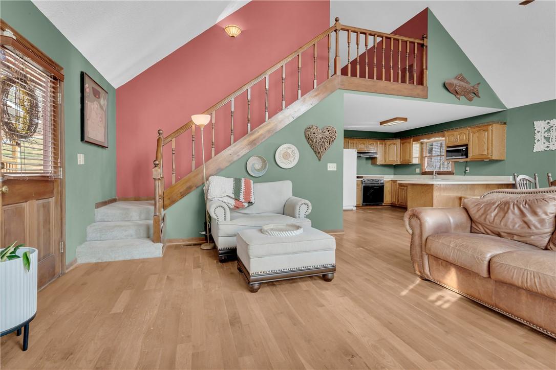 Image 4: This inviting interior features a staircase leadin