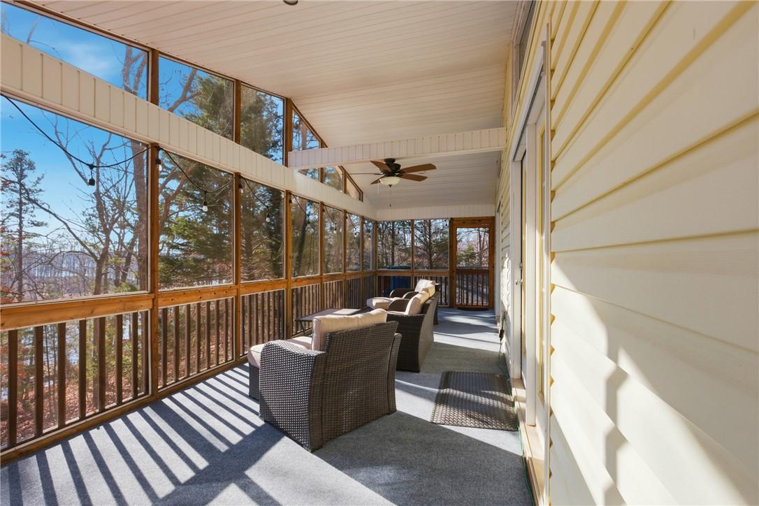 Image 2: This inviting porch offers tranquil views, perfect