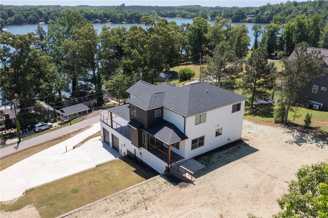 Image 4: This modern home offers expansive lake views and a