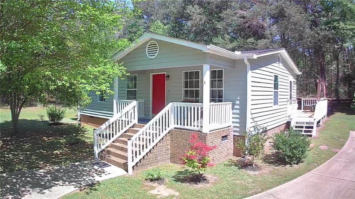 Image 4: This charming home offers a welcoming front porch