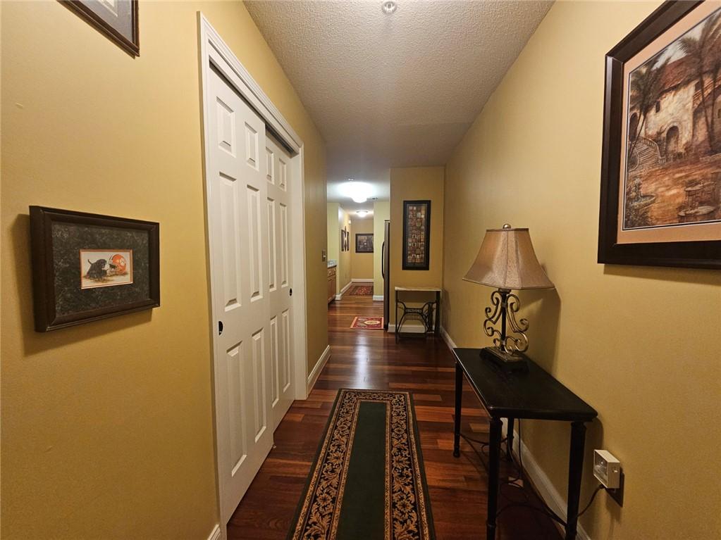 Image 2: Rich hardwood flooring leads the way down a natura