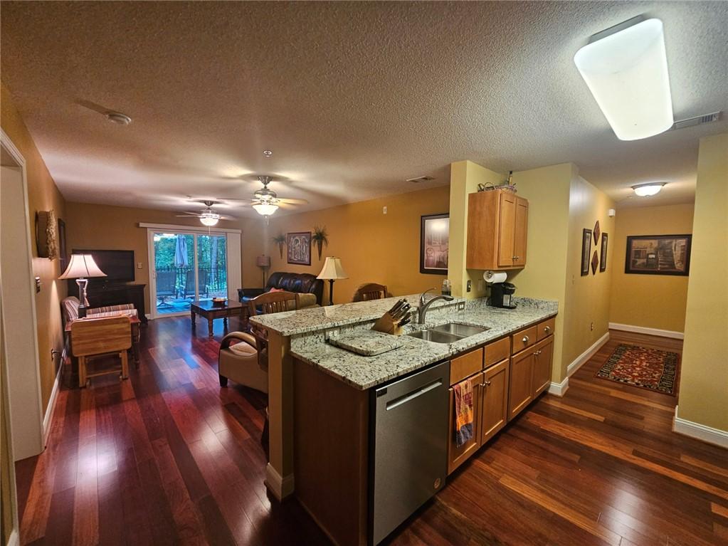 Image 3: An open-concept living area with lustrous hardwood