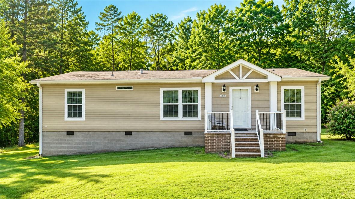 Image 1: A welcoming front entrance with a charming porch a
