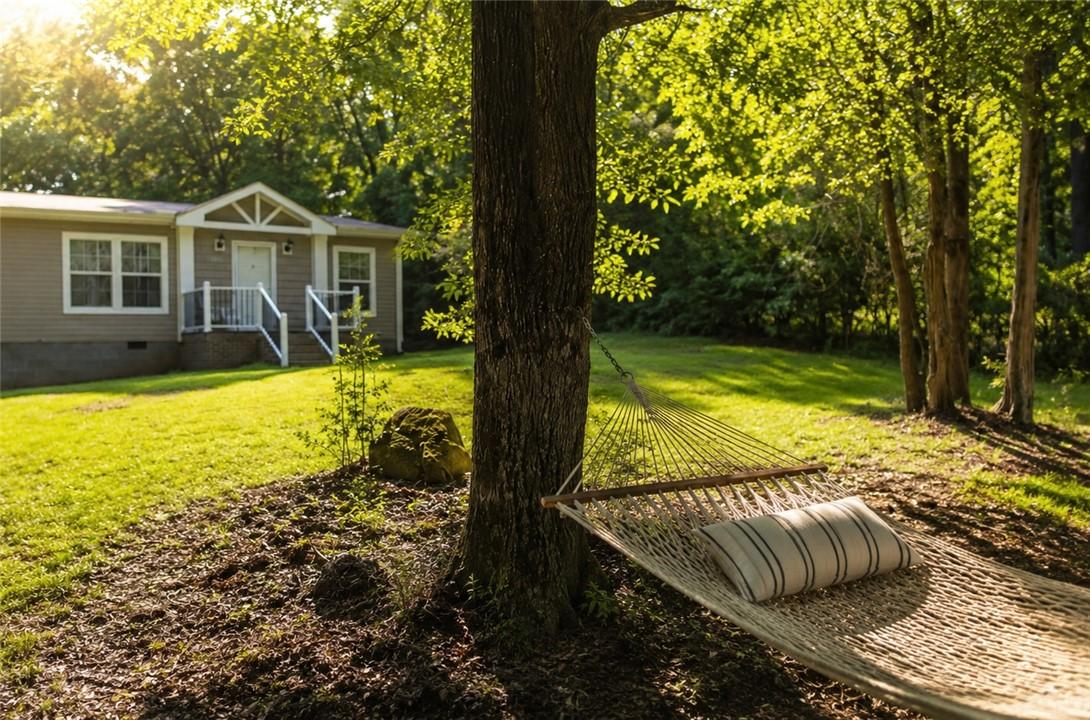 Image 2: A tranquil backyard setting with a hammock provide