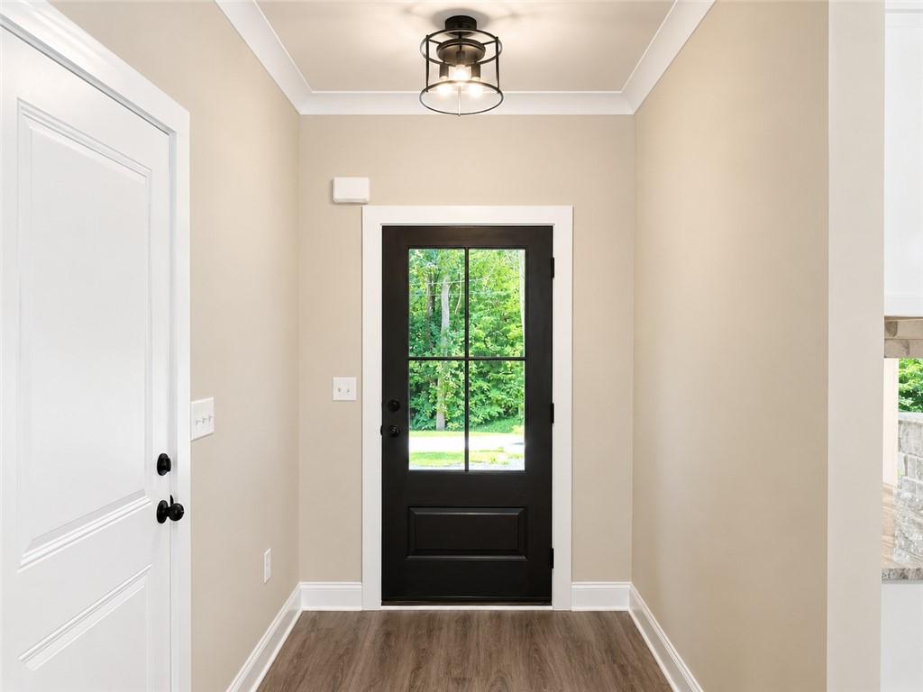 Image 2: A welcoming entryway with rich wood-look flooring