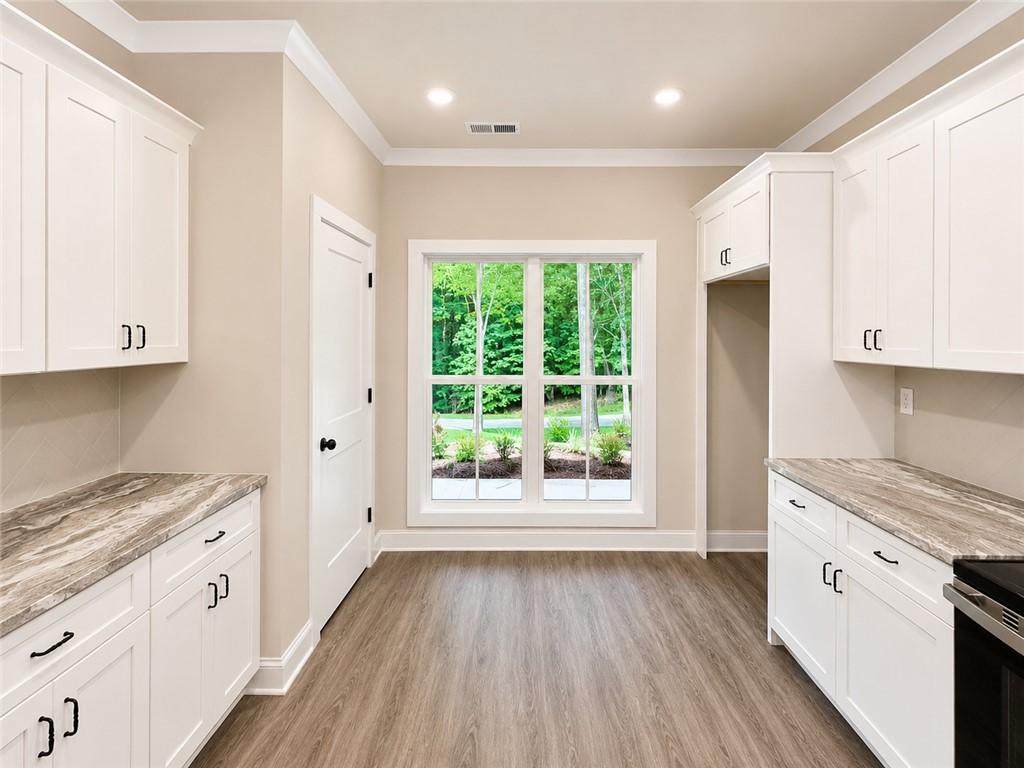 Image 4: A well-appointed kitchen features ample cabinetry