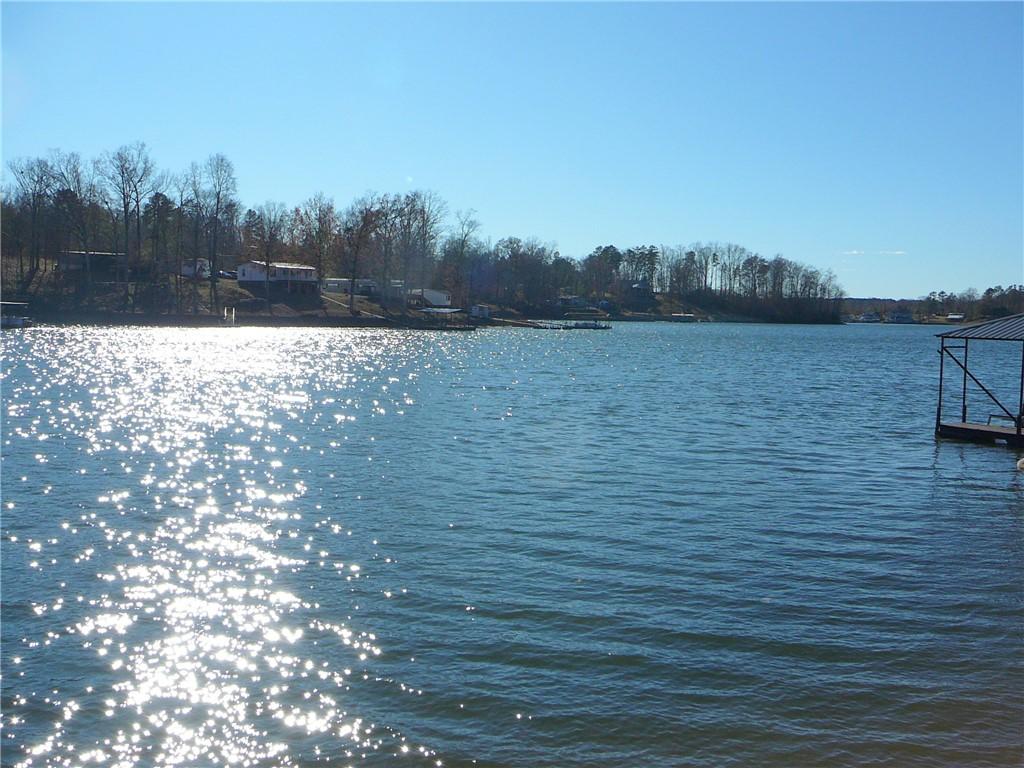 Image 1: A tranquil lake scene with a distant treeline and